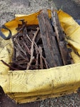 Skip bag and wood Mix of: wood (decking, timber support for the decking, wooden gate, some branches, 2 pallets), garden waste (leaves, soil), sand, pebbles and blocks of rubble/sand. Includes metal from nails in the wood, gate hinges + latch. NE7 - removed for £150