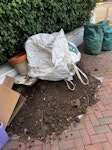 Soil and garden waste a mound of soil, 3 additional bags of soil and some smaller pieces of waste (boards and a plant pot) SW20 - removed for £100