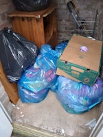 Bags of toys and cupboard collected by Ram it in skip hire