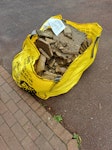 Bag of rubble Patio base been removed prior to further works PE2 - removed for £175