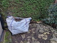 Bag of tree branches and trunk collected by Marylebone Waste Management LTD