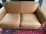 Old sofa 180cm w x 95 cm d Leather sofa two seater 180cm w x 95cm d. Fading and pet scratches but functional if anyone needs an old sofa. CB2 - removed for £165