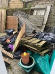 A sofa, garden waste and junk Old wooden pallets, plant pots, bags of garden waste, one large sofa N1 - removed for £180