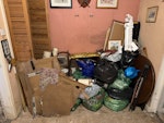 Assorted rubbish Some kitchen Lino and underlay, two chairs, a round wooden table and base, plus bin bags of household waste. M35 - removed for £80