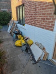 Assortment of building waste Mainly consisted of wood, MDF, particle boards and drywall. Some metal railings and household items including a small BBQ, 1 and half bags of bark chippings and a watering can. No electricals or hazardous waste. 

Free parking on Lyndhurst Avenue , about 20 meters from site. 

Easy access to waste at the front of the house. SW2 - removed for £170