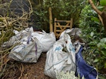 Garden waste 8 big bags with green waste (most half full), some branches and few light fence posts N20 - removed for £150