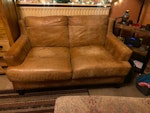 Tan leather sofa (2 seat) Tan leather sofa, slightly stained in the seats with liquids but could be rejuvenated and reused. B14 - removed for £60