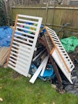 pile of mostly wooden watse random assortment of wooden crate, kids bed frame and random bits of broken pallet and other garden waste like sticks and logs SE19 - removed for £100