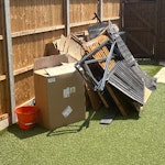 Wood, cardboard, garden Fence panels, shed broken down, lots of cardboard. Some bits of metal with hinges in there and few other small bits. KT12 - removed for £100