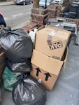 cardboard and packing material please remove the large stack of broken down cardboard boxes behind the bins, the 5 black garbage bags and 2 cardboard boxes filled with packing material, the bit of styrofoam, the metal bin, carpet roll, and floor samples. DO NOT take the bike, the bins, or the black cover under the bike (those belong to our neighbour). E5 - removed for £65