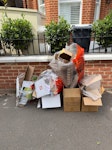 pile of cardboard sorted paper and cardboard that the rubbish men didn’t collect SW19 - removed for £50