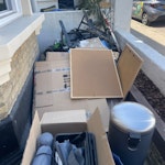 household waste mixture of cardboard boxes, garden waste, household bin (empty), empty plastic frames, x1 tall plant, SW2 - removed for £200
