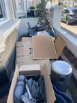 household waste mixture of cardboard boxes, garden waste, household bin (empty), empty plastic frames, x1 tall plant, SW2 - removed for £200