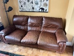 Broken 3 seater leather couch The couch has two broken springs and not worth us fixing at this stage. It’s a little heavy. We will have to remove feet to get it out front door. TW1 - removed for £95
