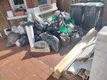 Building waste from bathroom Building waste from a bathroom renovation, including old tiles and insulation (black bags), broken up plasterboard (green bags), old wood, a sink, and shower screen. N4 - removed for £250