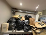 cardboard clothes and toys only some items are reusable. 
lots of cardboard - mostly flattened, some bags of recylcing and paper trash, clothes in good condition, toys, baby items. WD17 - removed for £100