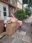 wood and paper all in fron of the house 
including 2 plastic bags N22 - removed for £85