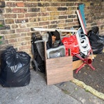 Misc house rubbish 2 bin bags, buggy and bike seat, box of misc W6 - removed for £160