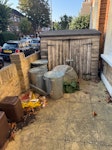 Bike shed and rubbish removal Clearance required from front and back garden. Items include: 2 x small brown food caddies, 1 x large rubble sack, several loose bags/cardboard/debris, dismantling and removal of 1 x wooden bike shed (approx. 1.5m high x 2m wide x 1m deep), plus from the rear garden: 1 x BBQ (approx. 1m x 1m), 1 x outdoor deck table and 4 x outdoor chairs. Access: street-level front garden; back garden accessible through the apartment. Metal dustbins to remain. SW18 - removed for £200