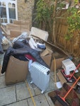 rubbish clothes electric heate just moved.karge cardboard pieces, rubbish, clothing, small freezer, electric heater W4 - removed for £180