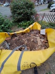 Breeze blocks, brick and soil Rubble from the deconstruction of a patio. The bag used is a hipposkip (l) and is around, perhaps slightly above the 25% line probably due to the breeze blocks. NN12 - removed for £280