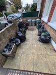 Rubbish for tip All items easily accessible at front of building

Approximately 14 black bin bags plus 10-15 other items unbagged. 

Black bin bags are mixture of garden waste and general garbage. 

Two bags of household chemicals (eg cleaners, garden sprays). 

unbagged items include poles, an old garden umbrella and stand, BBQ cooking steel ring and flower pot. SW18 - removed for £100