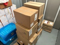 Cardboard boxes of unused PPE collected by Dorset Waste Clearance
