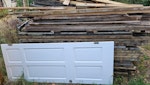Scrap timber -decking and door Scrap timber decking previously a balcony, an internal door, chip board, floorboards, timber posts, timber fence, softwood 2x4s, pallet, 1 scrap wheelbarrow, bags of dried cement, gravel, off cuts of porcelain tiles. BS21 - removed for £340