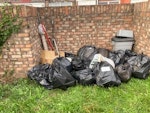 17 bags & misc household 17 bags containing plastic bags/paper/ miscellaneous household items, 1 cardboard box, 3 mops,bucket, 2 walking sticks, 1 curtain rail, 1 roll vinyl flooring. SE2 - removed for £100