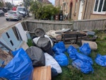Random items & garden waste There is a mixture of furniture waste, old metal bed frame, wooden stand, outdoor gazebo, old garden furniture, old BBQ and stand and old dismantled wardrobe.  Bags with soil and rubble. Box of old kitchen equipment. Duvet and mattress protector. Printer and other items TW8 - removed for £140