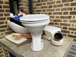 bathroom sink and toilet ceramic sink, toilet small section case iron pipe old mortar gone off, small bundle of wood E9 - removed for £80