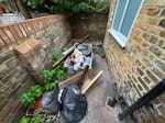 water tank and some rubbish some building waste in the garden W6 - removed for £75