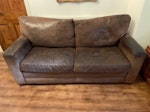 2 seater sofa and armchair Two seater leather sofa measuring 190cm wide by 90cm depth. Leather armchair measuring 93cm wide by 100cm depth. Both in good structural condition. Some scratches and wear to leather as seen in photos SE25 - removed for £80