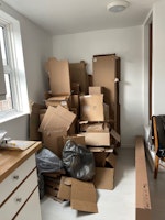 20-30 flat cardboard boxes collected by Junk Truck