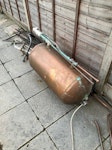 Pipes, tank, renovation waste Copper tank and pipes.
Old water tanks cut into pieces.
Bags of stripped wallpaper. Hot water cylinder jacket. Delivery pallet. Other bags of waste. NW2 - removed for £143