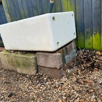 shed with pots, cinder blocks collected by Universal N&D LTD