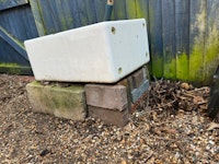 shed with pots, cinder blocks collected by Universal N&D LTD