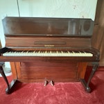Upright piano. Has wheels, but may need planks to move up/ down steps. Good exterior wood condition, needs tuning and possibly felt repairs if to be playable. EX33 - removed for £120