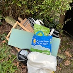 pipes, concrete, plastic, rack two buckets and one bag of plastic trash, old clothes drying rack, 6 soil pipes of ca 1 meter each, pieces of wood, two large solid tubular objects, piece of foam NW5 - removed for £65