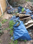 Garden waste and rubble garden waste including 3 broken fence panels and small branches. Approx 35 small bags of rubble and a couple of broken pots. In back garden but accessible directly by side entrance E6 - removed for £314