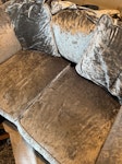 Two seater settee Grey velvet, two seater settee with loose cushions. Damage to corners on the right. ST5 - removed for £64