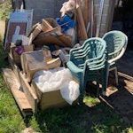 Unwanted from previous owner Empty boxes, bits of wood and metal, plastic chairs, tiles, cushions, cot and breakfast bar chairs. EN1 - removed for £247
