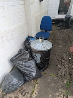 Bags of junk, and office chair collected by Wanitgone Waste Clearence