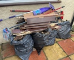 wood fence and cleaning tools x 5 black bags of broken down wood fencing. Lose broken down wood door. Vileda cleaning poles. NW2 - removed for £86
