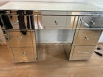 mirrored desk with draws a mirrored desk with draws, it’s quite heavy, bottom right draw handle is off and mirror cracked but could still be used /repaired E11 - removed for £91