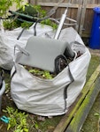 household and garden stuff Two 1 ton size bags of garden and household waste. Plus 2 or 3 bin bags small bits of wood, 2 pieces gate post, and household waste, chair, fabric style wheelbarrow old plant pots 
NOTE  access is to rear of property on Brett Street. Large gates immediate easy access
NO builders rubble M22 - removed for £141