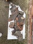 About 10-15 bricks/tiles We had a dig in the garden and when we were filling in the hole we left out some of the larger pieces of stuff-a few bricks and bits of tile E2 - removed for £57