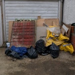 Pallets, boards, mirror, bags Mixed DIY waste for collection from driveway. Includes x2 wooden pallets, several timber boards/panels, empty yellow bulk bags, plastic sheeting/tarpaulin, a mirror, a small amount of loose mixed waste and three rubble bags. Easy outdoor access on driveway. NW2 - removed for £104