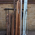Wooden/plastic planks/H'dboard An old metal bedhead stead, some wooden planks and the remains of and old metal/plastic awning. SE16 - removed for £100