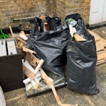 8 bags + Wood + Cardboard 8 bags of mixed rubbish (wood offcuts and general household) + Flattened Cardboard boxes + Wood + bathroom mirror + 2 sacks of half empty 10kg multifinish bonding powder SW13 - removed for £130